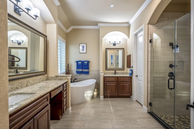 bathroom with a sink, a stall shower, and ornamental molding