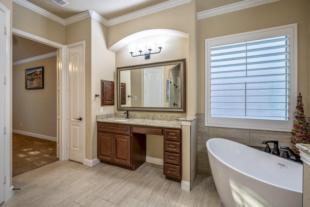 full bathroom with visible vents, a freestanding bath, ornamental molding, wood finished floors, and vanity