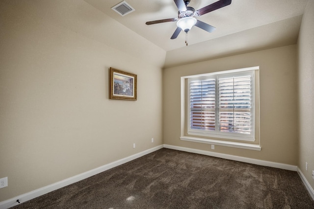 empty room with baseboards, visible vents, dark colored carpet, and ceiling fan