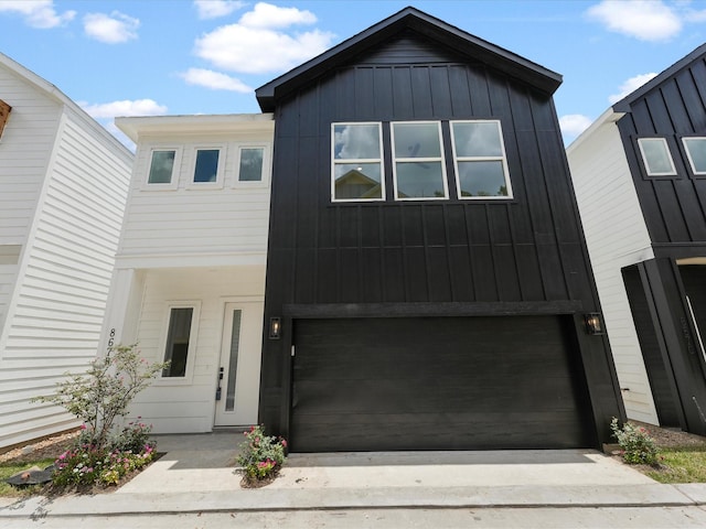 view of front of house featuring concrete driveway, a garage, and board and batten siding