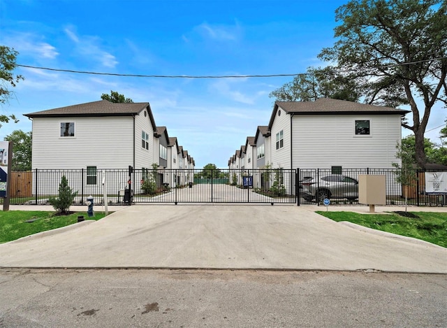 view of street with a gated entry, a residential view, and a gate