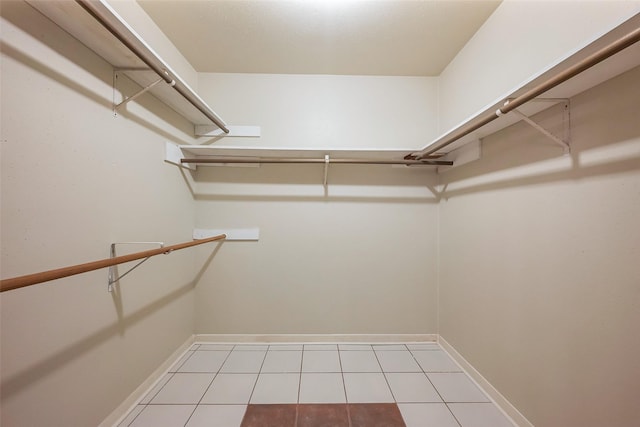 walk in closet featuring light tile patterned flooring