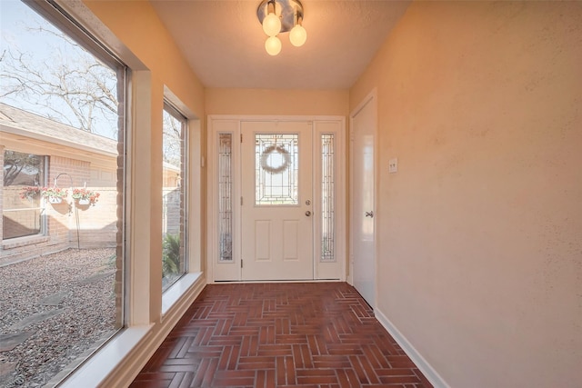 foyer entrance with baseboards