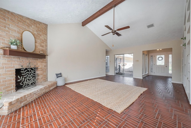 unfurnished living room featuring beamed ceiling, visible vents, high vaulted ceiling, baseboards, and a brick fireplace