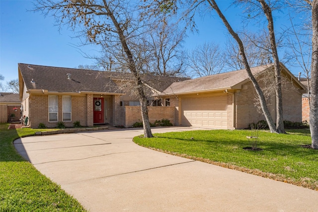 ranch-style house featuring driveway, brick siding, an attached garage, and a front yard