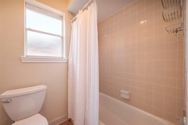 bathroom featuring toilet and shower / bath combo with shower curtain