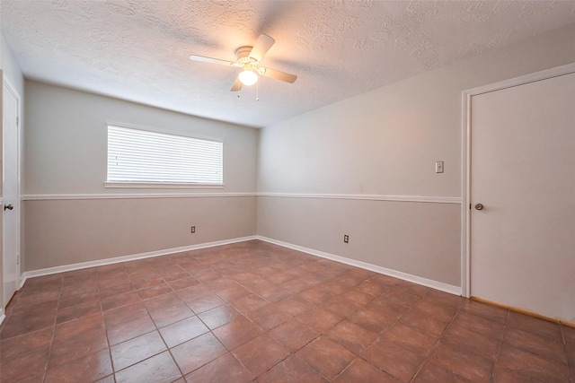 unfurnished room featuring a textured ceiling, baseboards, and ceiling fan