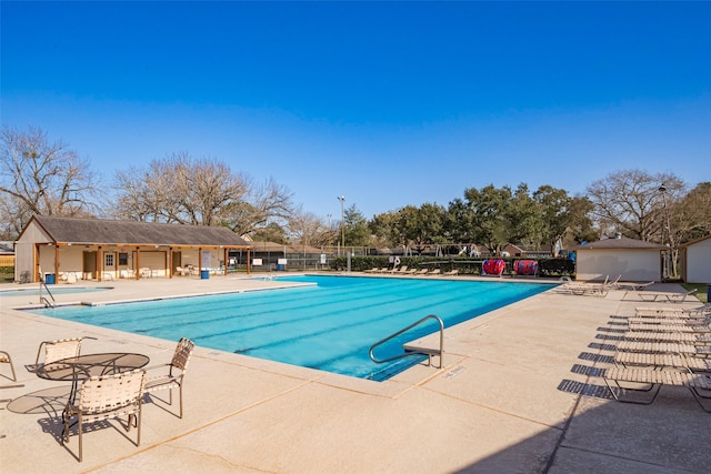 pool featuring a patio and fence