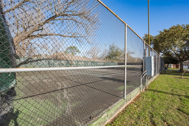 view of sport court featuring fence