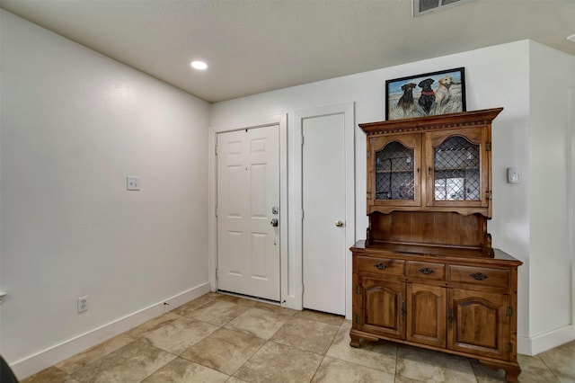 entrance foyer with visible vents and baseboards