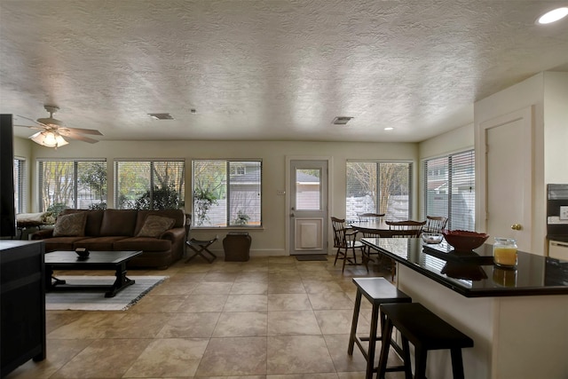 living room with light tile patterned flooring, visible vents, recessed lighting, and ceiling fan