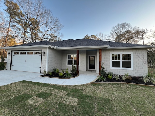 ranch-style home featuring an attached garage, a shingled roof, driveway, and a front lawn