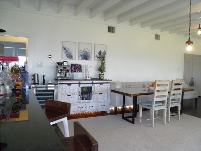 dining room with beam ceiling, visible vents, beverage cooler, and carpet floors