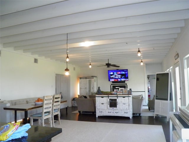 kitchen with beam ceiling, dark wood-style floors, a ceiling fan, and visible vents