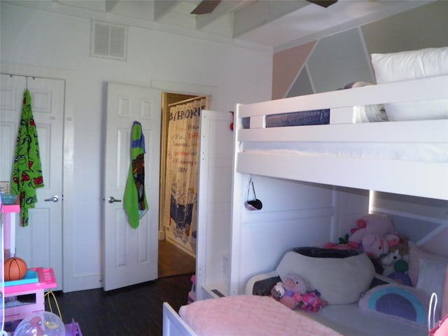 bedroom with dark wood-style floors and visible vents