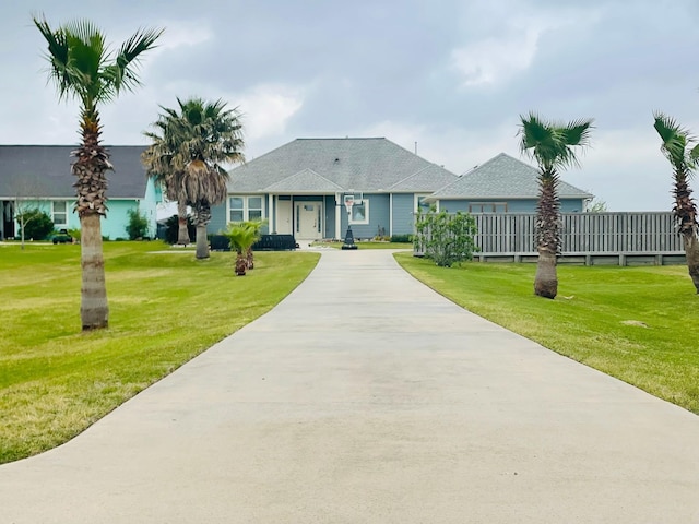 ranch-style house featuring driveway and a front yard