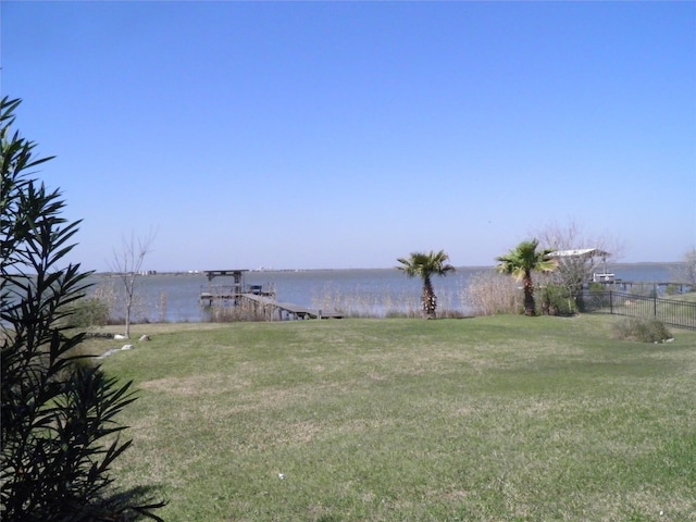 view of yard featuring a water view and fence