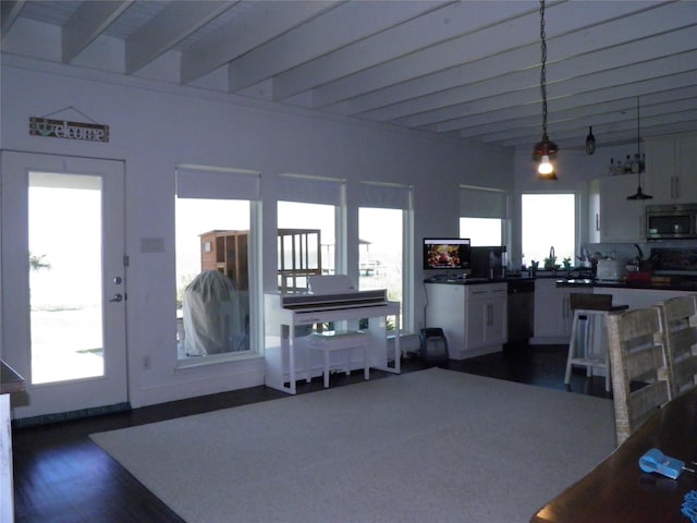 living area with dark wood finished floors and beam ceiling