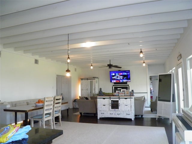 kitchen featuring a ceiling fan, dark wood-style flooring, beamed ceiling, and visible vents
