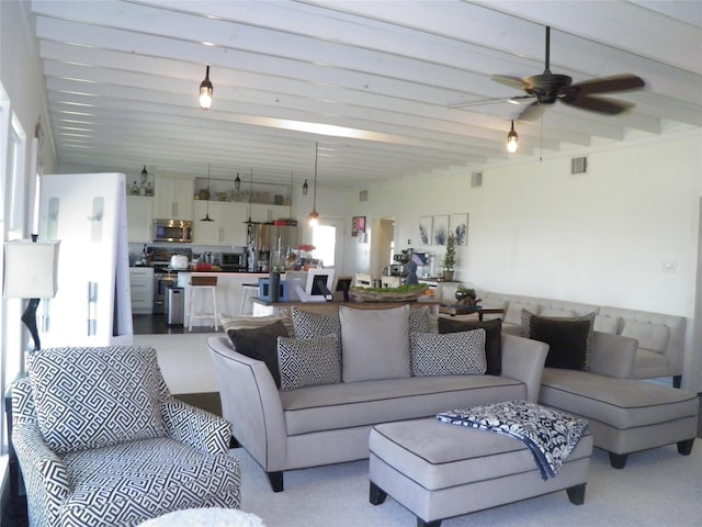 living room featuring visible vents and a ceiling fan