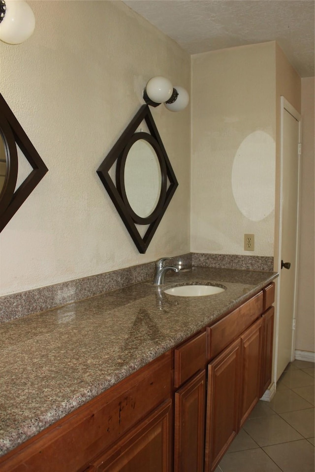 bathroom with tile patterned floors and vanity