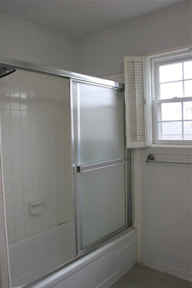 full bathroom with shower / bath combination with glass door