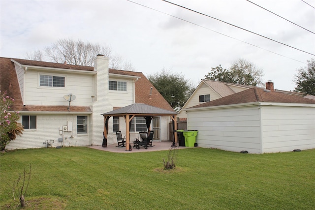 back of house with a gazebo, a lawn, and a chimney