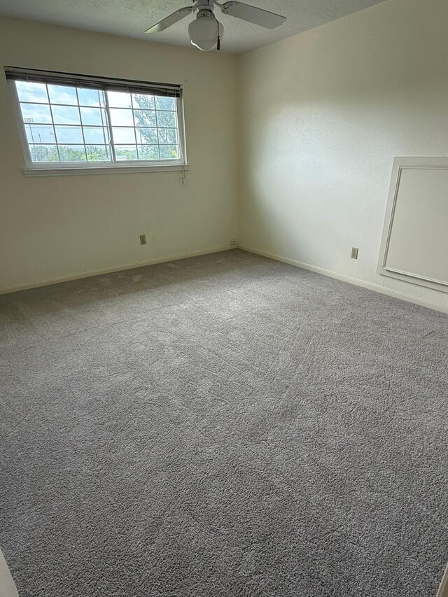 1727 Eastfield Dr, Missouri City, TX 77459 - carpeted empty room with a ceiling fan and baseboards