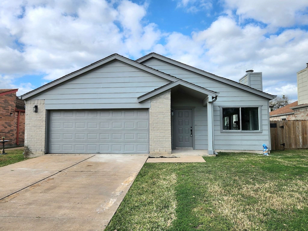 ranch-style house featuring fence, an attached garage, a front yard, brick siding, and a chimney