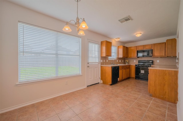 kitchen with visible vents, black appliances, an inviting chandelier, light countertops, and hanging light fixtures