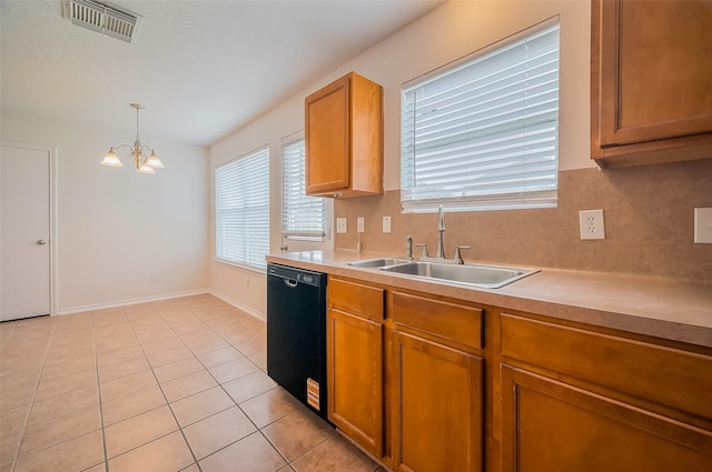 kitchen featuring light countertops, black dishwasher, visible vents, and a sink