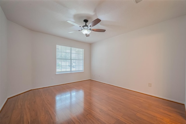 unfurnished room with light wood finished floors and ceiling fan