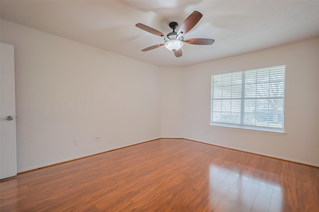 spare room with a ceiling fan and wood finished floors