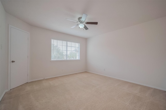 empty room with light colored carpet and ceiling fan