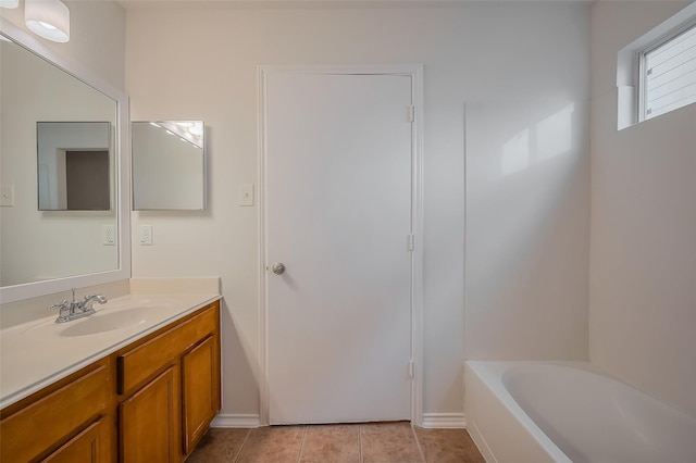 full bathroom with vanity, tile patterned floors, and a tub