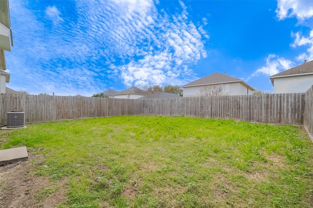 view of yard featuring central air condition unit and a fenced backyard