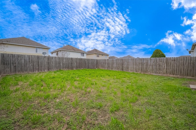 view of yard with a fenced backyard