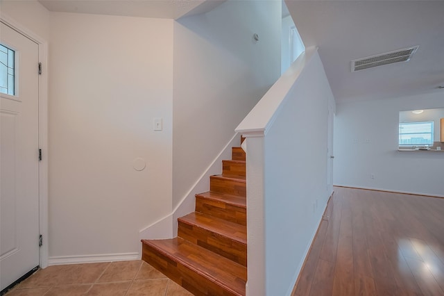 entryway featuring visible vents, baseboards, stairs, and tile patterned flooring