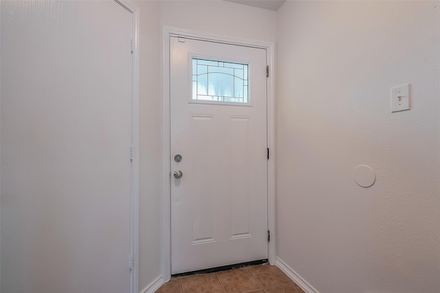 entryway featuring baseboards and light tile patterned flooring