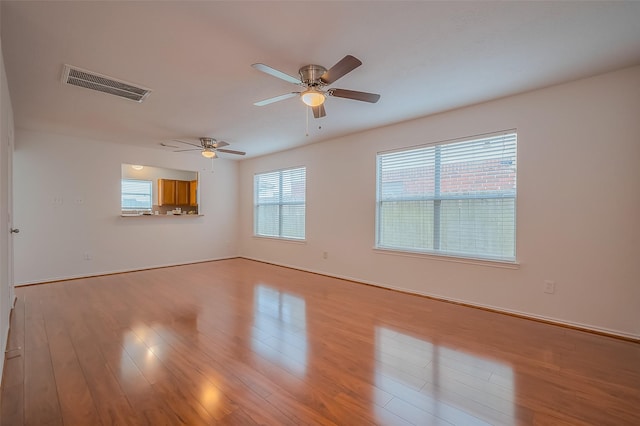 empty room featuring light wood-style floors and visible vents