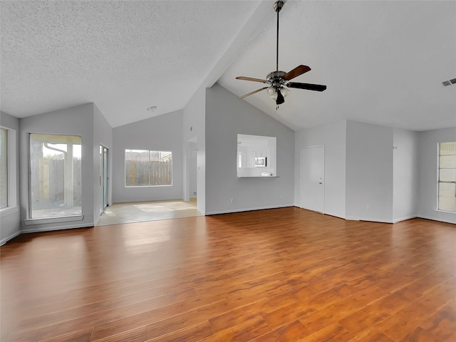 unfurnished living room with visible vents, a textured ceiling, a ceiling fan, and wood finished floors