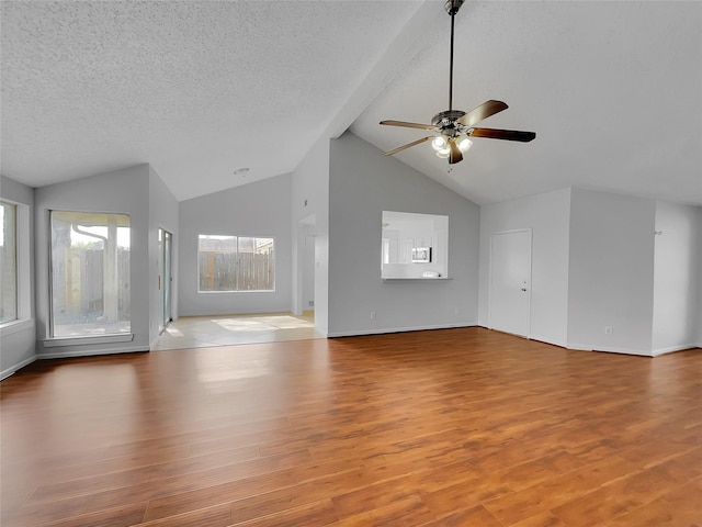 unfurnished living room featuring high vaulted ceiling, a textured ceiling, ceiling fan, and wood finished floors