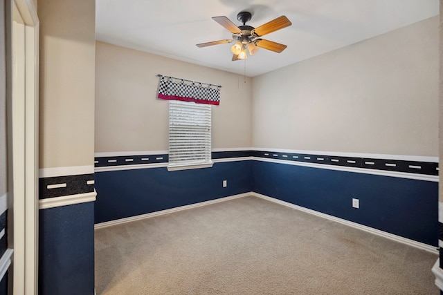 carpeted empty room with baseboards and ceiling fan