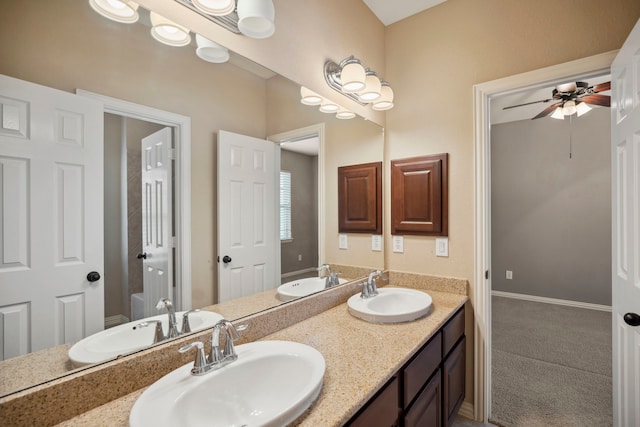 bathroom featuring a sink and double vanity