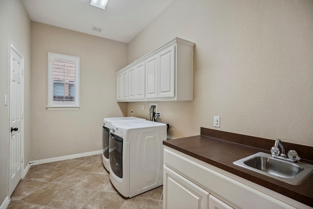 laundry area featuring visible vents, a sink, baseboards, cabinet space, and separate washer and dryer