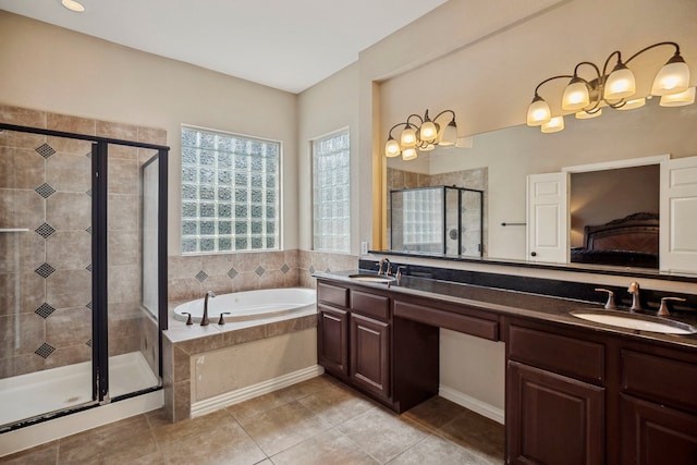 ensuite bathroom featuring a bath, a shower stall, double vanity, and a sink