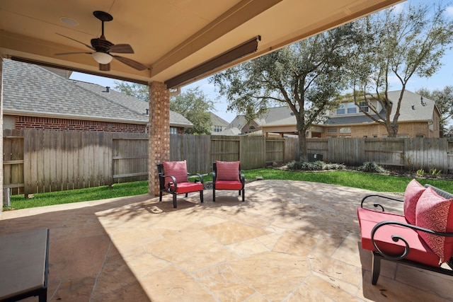 view of patio with a fenced backyard and ceiling fan