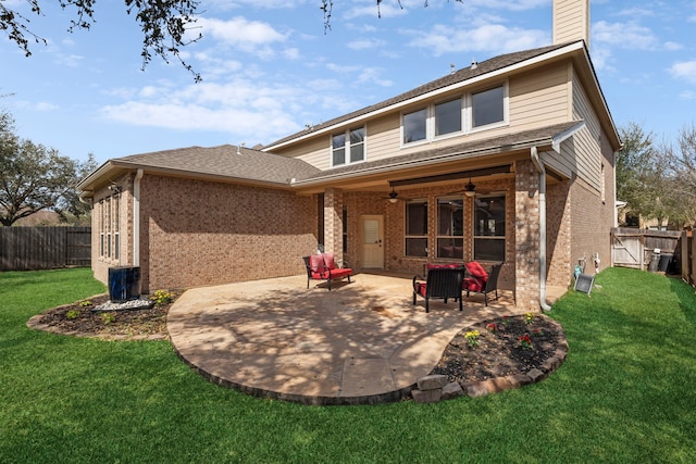 back of house featuring brick siding, a fenced backyard, a patio area, and a ceiling fan