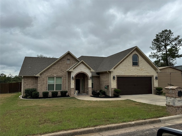 view of front of home with driveway, roof with shingles, a front lawn, a garage, and brick siding