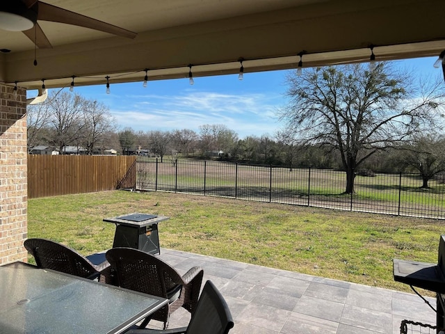 view of patio with a fenced backyard and ceiling fan